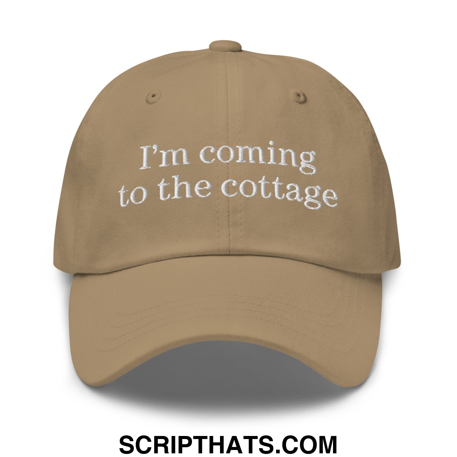 Tan unstructured dad hat baseball cap with white embroidered text reading im coming to the cottage