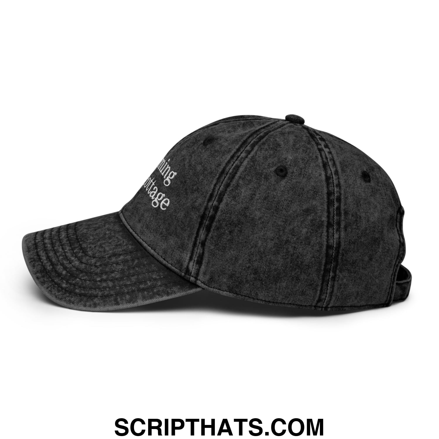 Black denim dad hat with white embroidered living in the cottage text from the im coming to the cottage collection