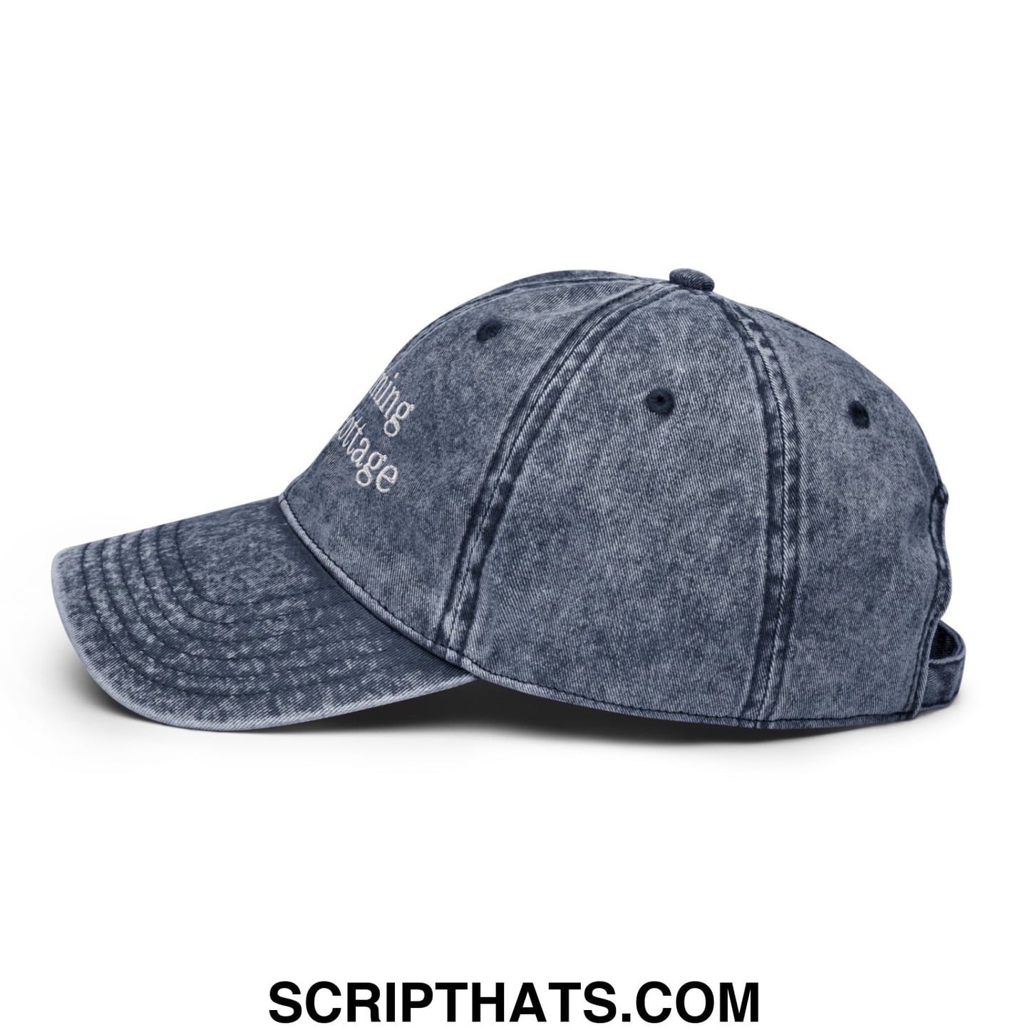 A faded blue denim dad hat with white embroidered text saying Im Coming to the Cottage on the front panel