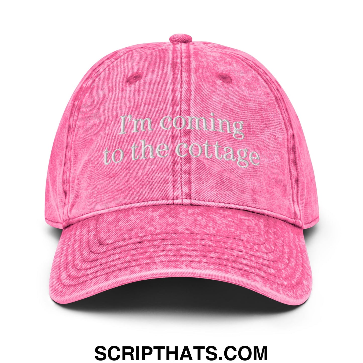 A faded pink unstructured denim dad hat with im coming to the cottage embroidered in white thread on the front