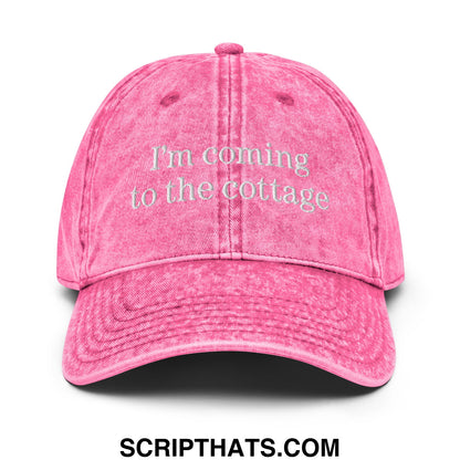 A faded pink unstructured denim dad hat with im coming to the cottage embroidered in white thread on the front