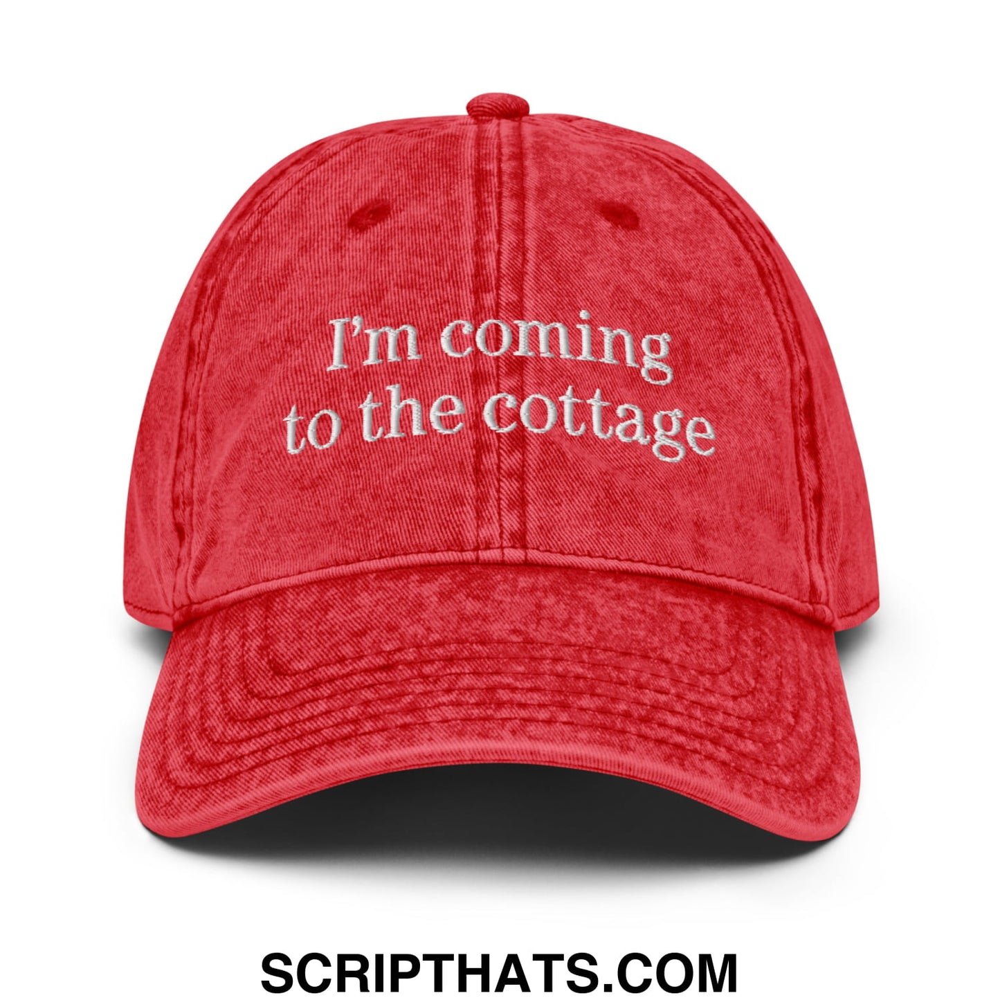 Red distressed cotton baseball cap with white embroidered text im coming to the cottage in an unstructured denim dad hat style