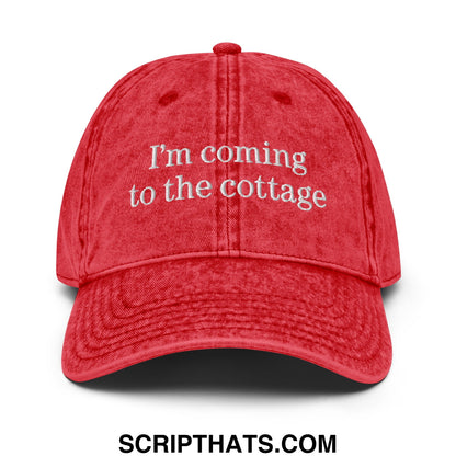 Red distressed cotton baseball cap with white embroidered text im coming to the cottage in an unstructured denim dad hat style