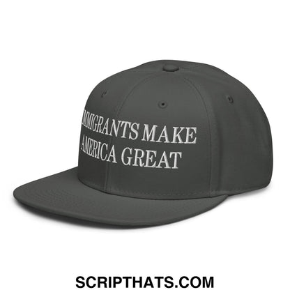 Dark gray snapback cap with white embroidered text immigrants make america great on the front panel