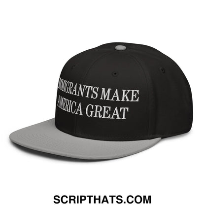 Black and gray snapback hat with white embroidered text immigrants make america great on flat brim bill