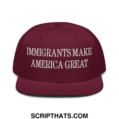 Maroon flat brim snapback hat with white embroidered text immigrants make america great on the front panel