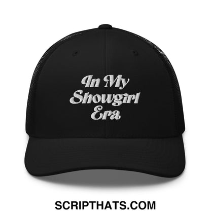 Black mesh trucker hat with white embroidered text reading in my showgirl era on the front panel