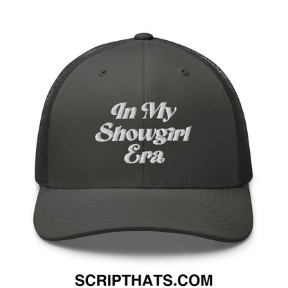 A dark gray mesh trucker hat with white embroidered text in my showgirl era on the front panel