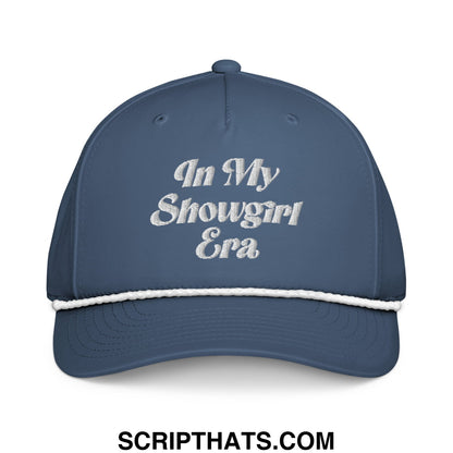 A navy blue embroidered rope hat with white stitched brim and text in my showgirl era on the front