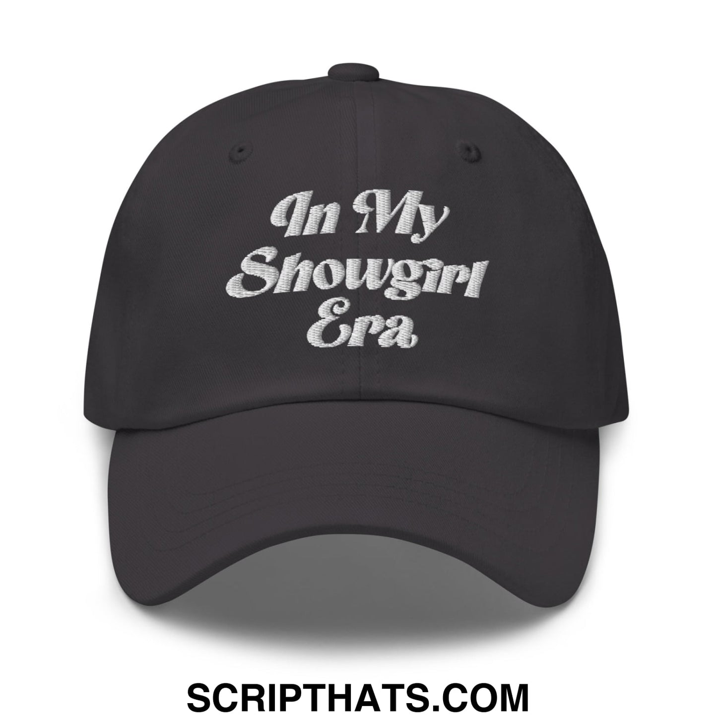 Black unstructured dad hat with white embroidered text reading in my showgirl era on the front panel