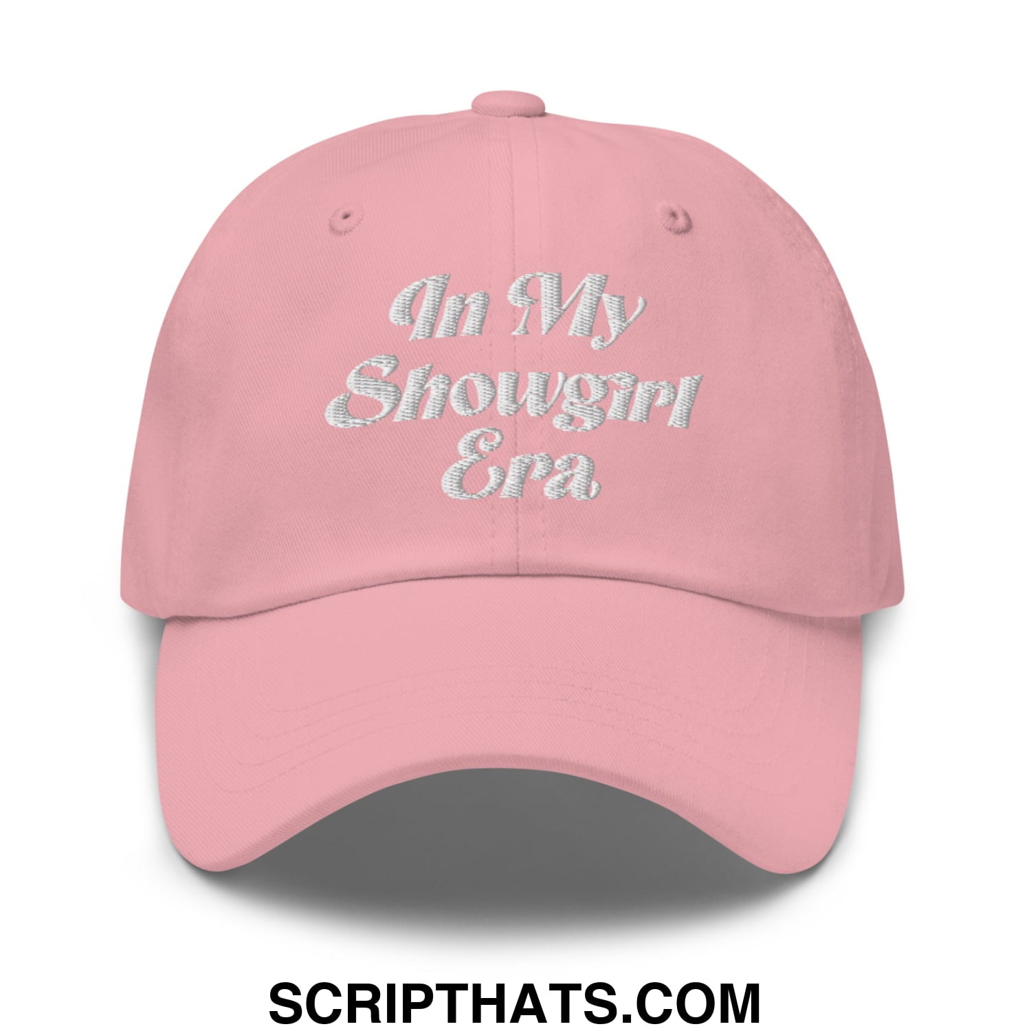 A soft pink unstructured dad hat embroidered with shimmering silver in my showgirl era script on the front