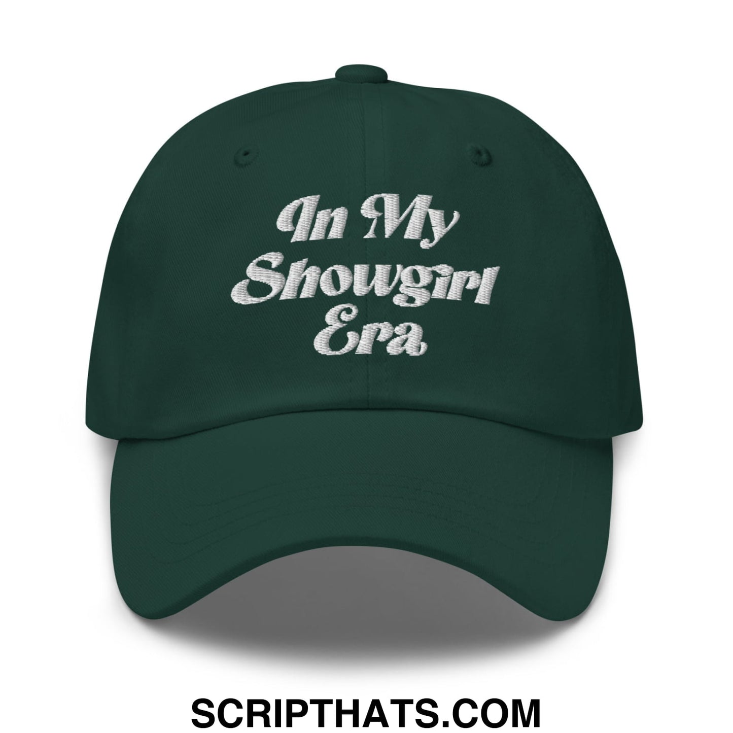Dark green unstructured dad hat with white embroidered text in my showgirl era on the front panel