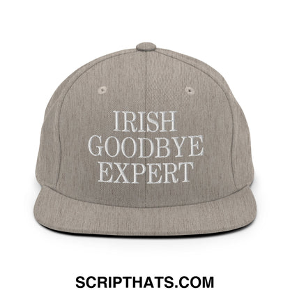 Gray snapback cap with white embroidered text irish goodbye expert featuring flat bill brim and adjustable closure