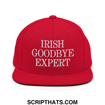 Red snapback cap with white embroidered irish goodbye expert text and flat bill brim for casual wear