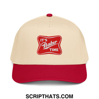 Cream-colored baseball snapback hat with red brim and button featuring embroidered its baker time patch in white script