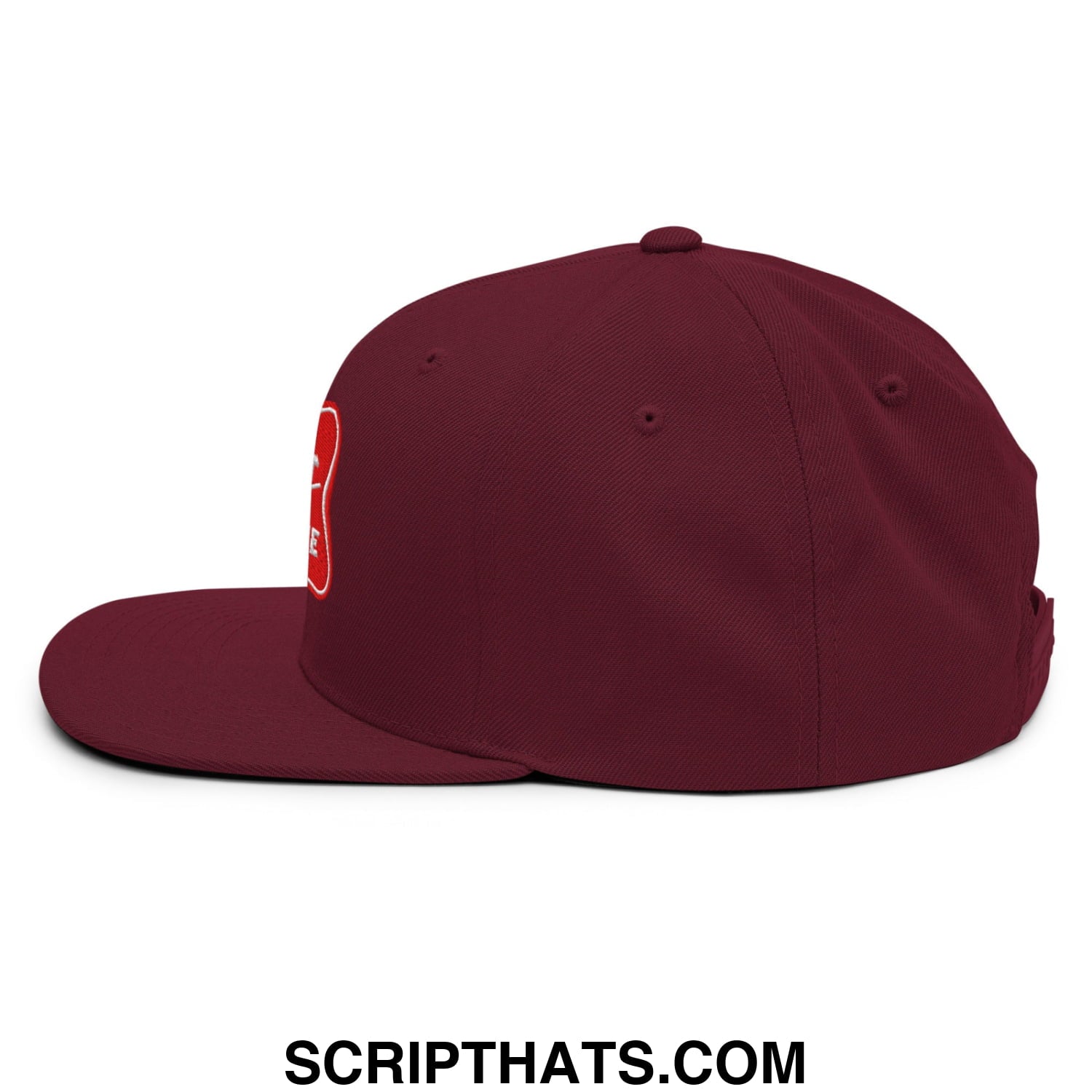 Maroon snapback cap with flat bill brim and red embroidered logo on the side from it’s baker time collection