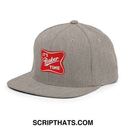 Gray snapback hat with a red embroidered patch reading its baker time in white script on a flat bill brim