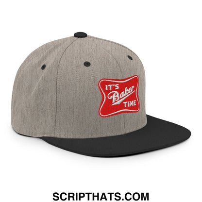 Gray and black snapback hat with red embroidered patch reading its baker time in white script on flat bill brim