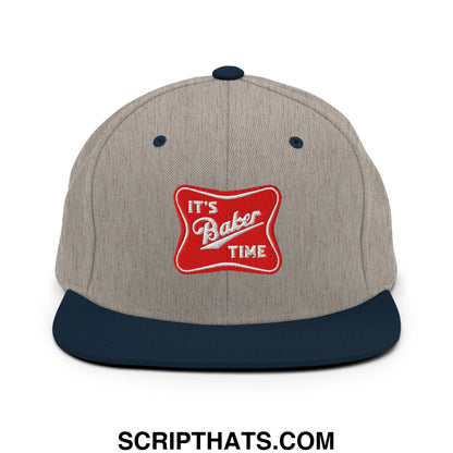 A heather gray snapback hat with a navy blue flat bill and red embroidered patch saying its baker time