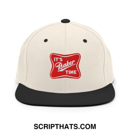 Cream-colored snapback hat with black flat bill and red embroidered patch reading its baker time in white script