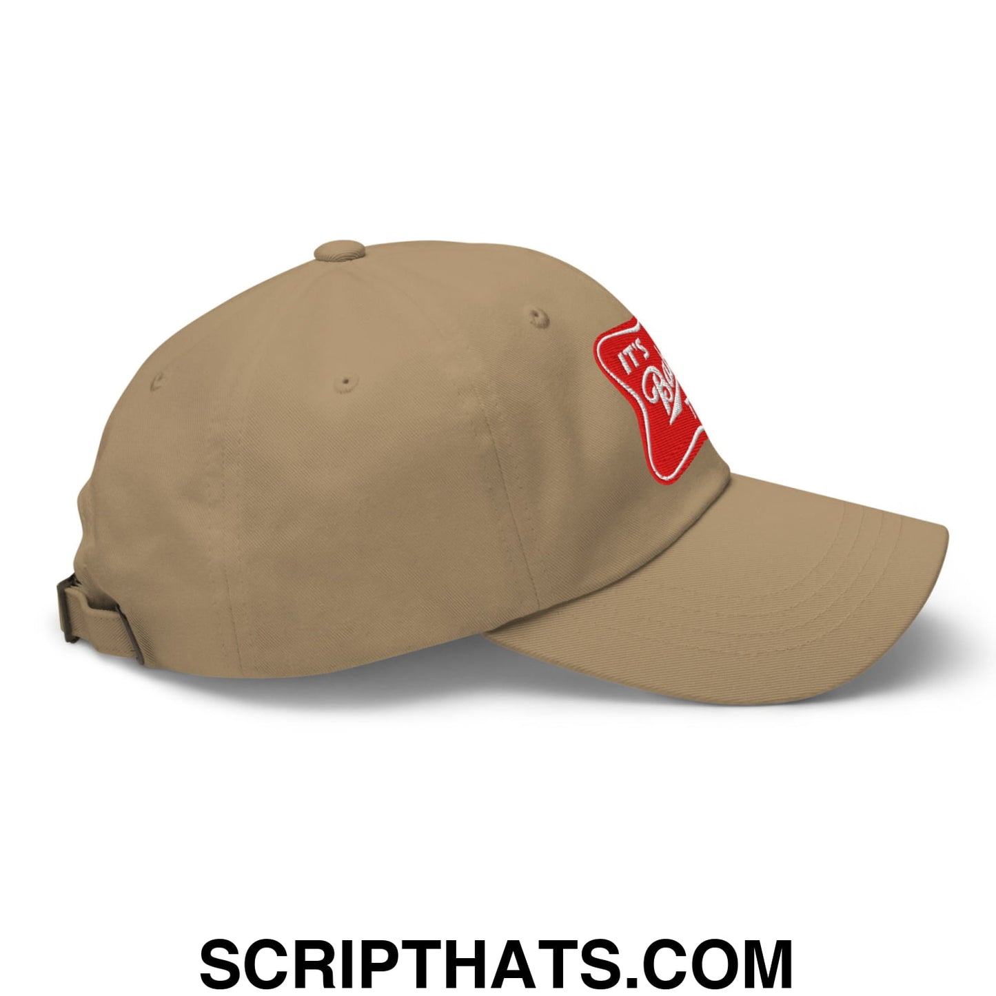 Tan unstructured dad hat with red embroidered patch on the side featuring its baker time design
