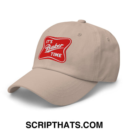 Beige unstructured dad hat featuring a red embroidered patch with white cursive text its baker time