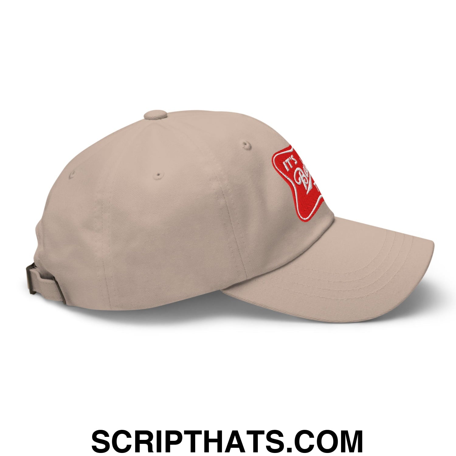 Beige unstructured dad hat with a red embroidered patch on the side called its baker time embroidered cap