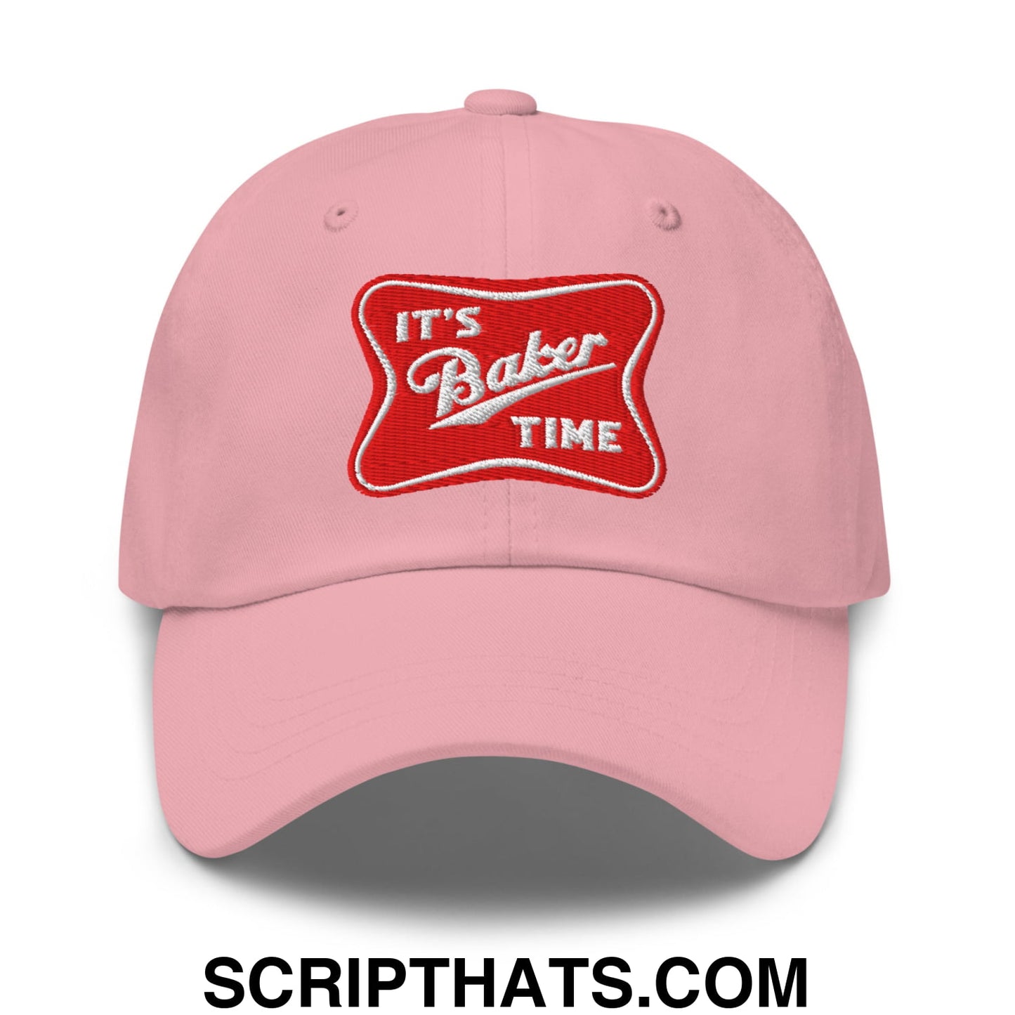 Pink unstructured dad hat with red embroidered patch that reads its baker time in white lettering