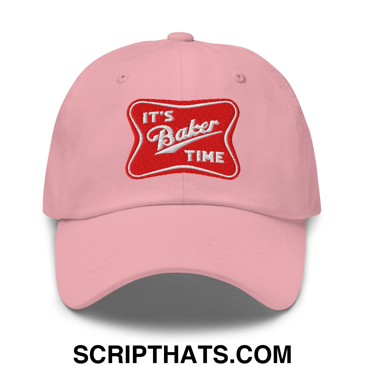 Pink unstructured dad hat with red embroidered patch that reads its baker time in white lettering