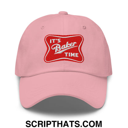 Pink unstructured dad hat with red embroidered patch that reads its baker time in white lettering