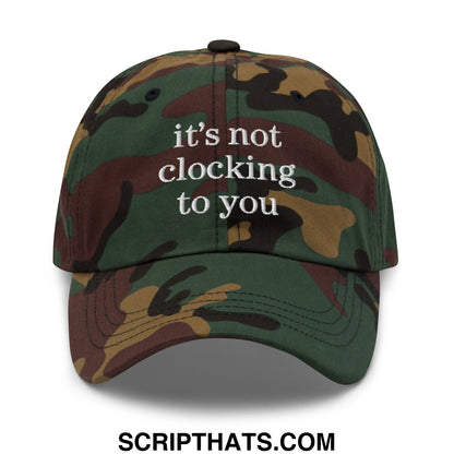 A camouflage-patterned unstructured dad hat with white embroidered text reading its not clocking to you