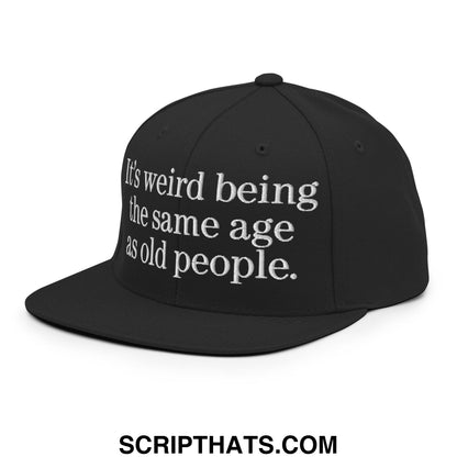 Black snapback cap with white embroidered text its weird being the same age as old people flat bill brim