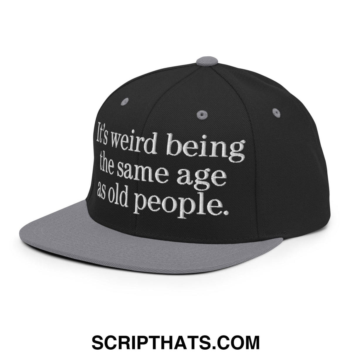 Black and gray embroidered flat bill snapback hat with white text reading its weird being the same age as old people
