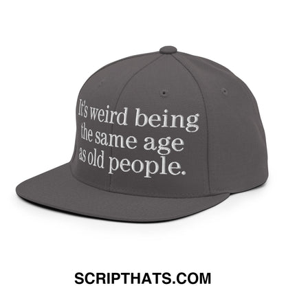 Gray flat bill brim snapback hat with white embroidered text its weird being the same age as old people
