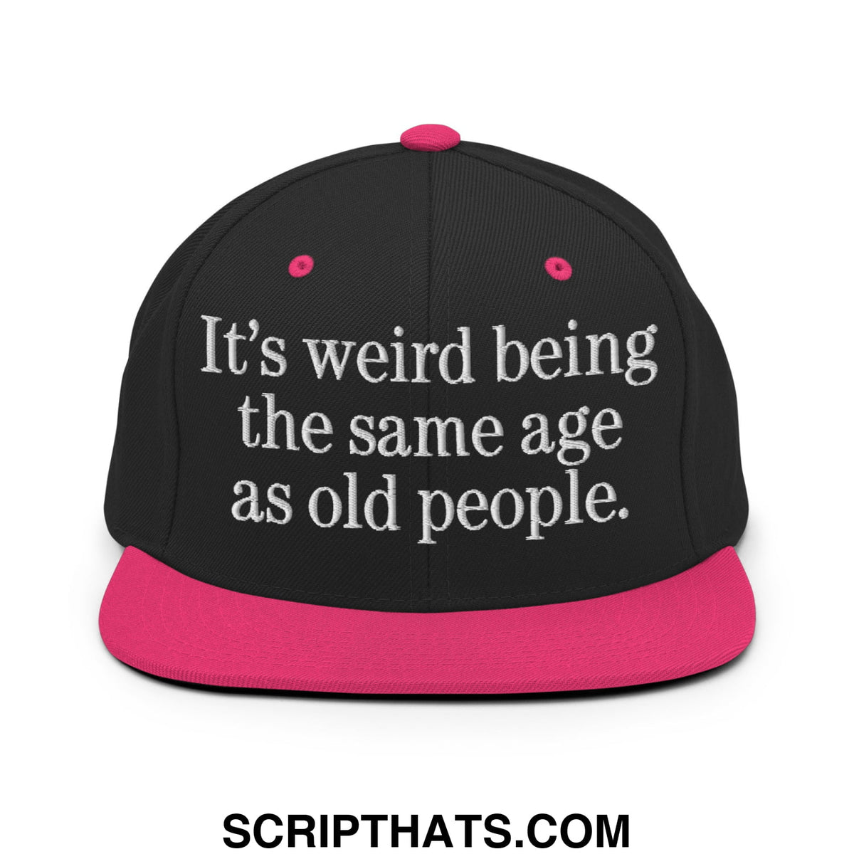 Black snapback hat with vibrant pink flat brim and white embroidered text it’s weird being the same age as old people