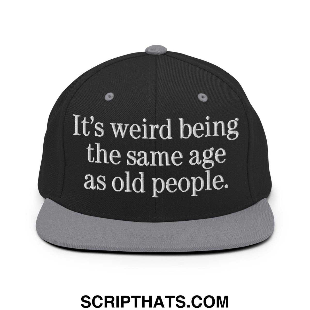 Black snapback cap with gray flat bill brim and embroidered white text reading its weird being the same age as old people