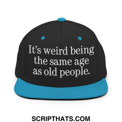 Black snapback cap with teal flat bill brim and white embroidered text it’s weird being the same age as old people