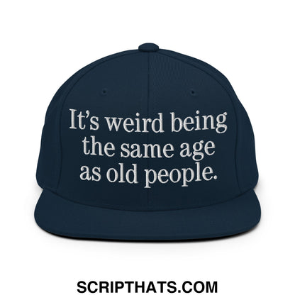 Navy blue snapback hat with white embroidered text its weird being the same age as old people flat bill brim