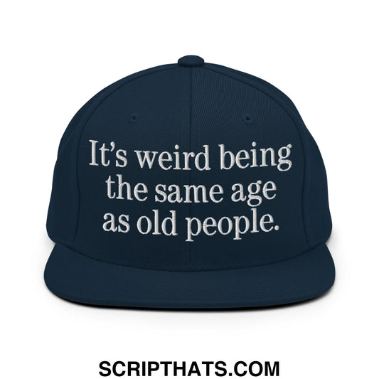 Navy blue snapback hat with white embroidered text its weird being the same age as old people flat bill brim