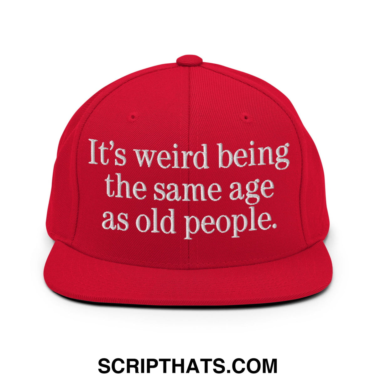 Red flat bill snapback hat with white embroidered text reading its weird being the same age as old people