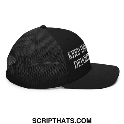 Black mesh trucker hat with white embroidered keep immigrants deport racists text on the side