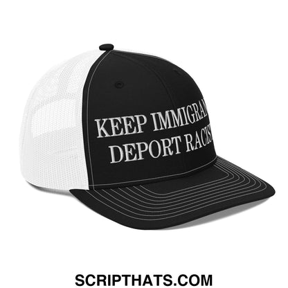 Black and white classic mesh trucker hat with embroidered keep immigrants deport racists text on the front panel