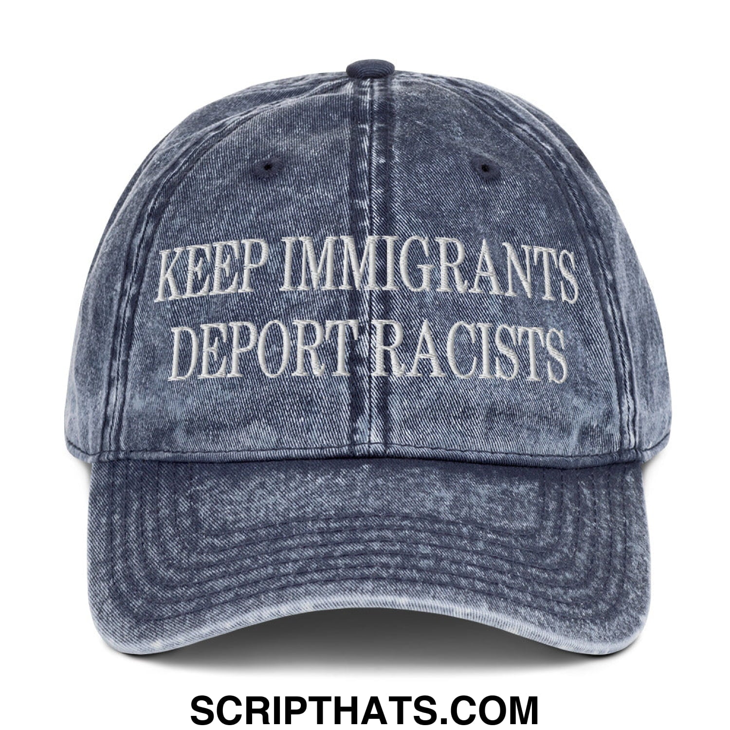 A faded blue denim dad hat with white embroidered text keep immigrants deport racists on the front panel