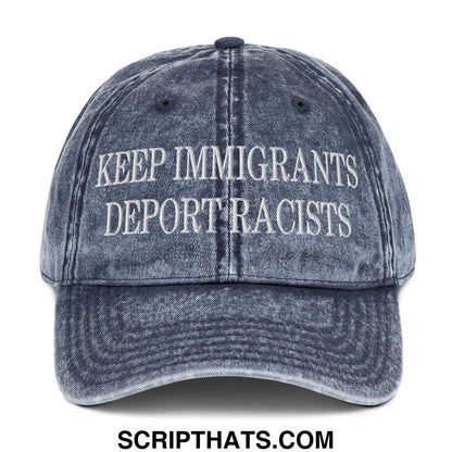 A faded blue denim dad hat with white embroidered text keep immigrants deport racists on the front panel