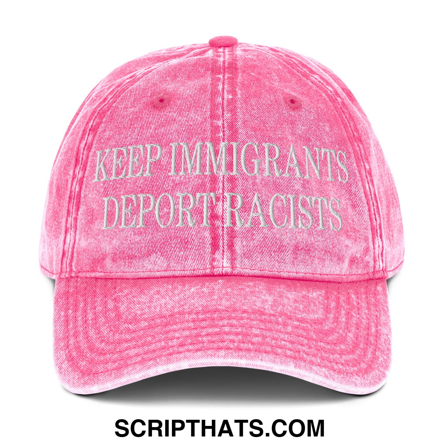 A faded pink denim dad hat with embroidered white text reading keep immigrants deport racists