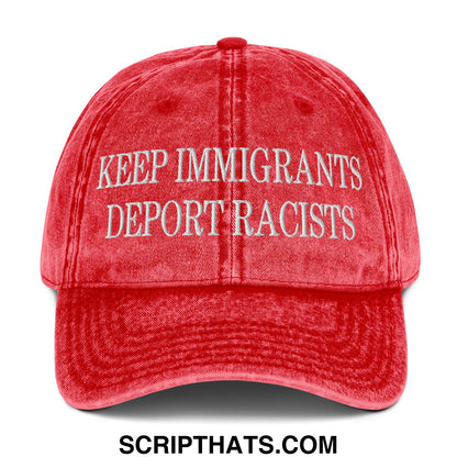 A faded red denim dad hat with white embroidered text keep immigrants deport racists on the front