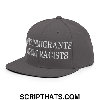 Gray snapback hat with white embroidered text saying keep immigrants deport racists featuring a flat bill brim