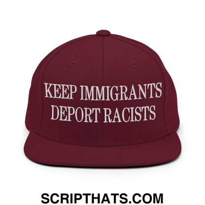 Maroon snapback hat with white embroidered keep immigrants deport racists text and a flat bill brim design