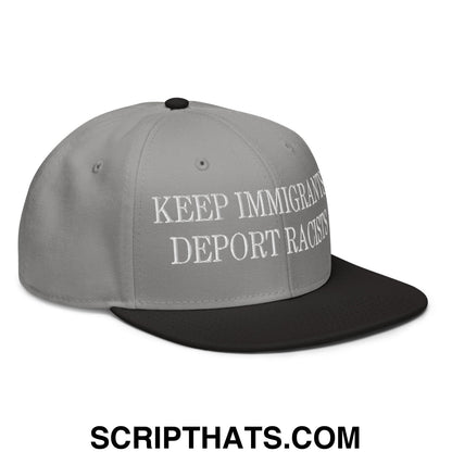Gray snapback cap with black brim and white embroidered text reading keep immigrants deport racists flat bill hat