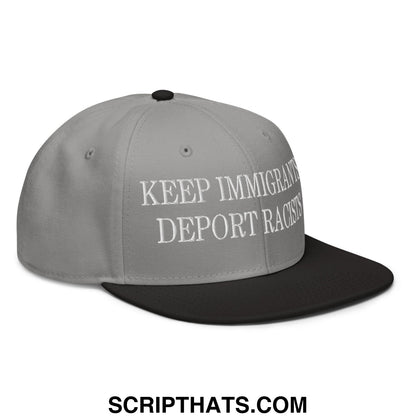 Gray snapback cap with black brim and white embroidered text reading keep immigrants deport racists flat bill hat